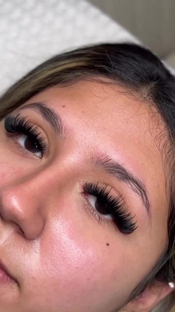 A client on the lash bed after her appointment